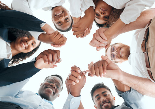 We Stand Together As A Team. A Group Of Businesspeople Holding Hands In An Office At Work.