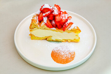 San sebastian ( Bask ) cheesecake slice isolated close up. Limon, lotus, fistikli, Frambuazli cheesecake