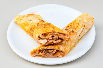 Lavash doner kebab ( zurna doner durum )  or shawarma sliced in plate isolated. 