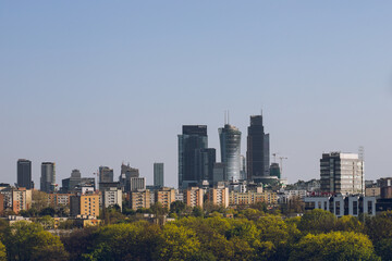 Fototapeta premium Observation deck with binoculars and a view of a modern business center with office buildings:Warsaw/Poland-22 April 2023