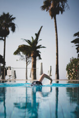 Fototapeta na wymiar Person swimming in a pool