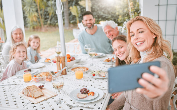 Everyone needs a house to live in. a family taking a selfie while having lunch at home.