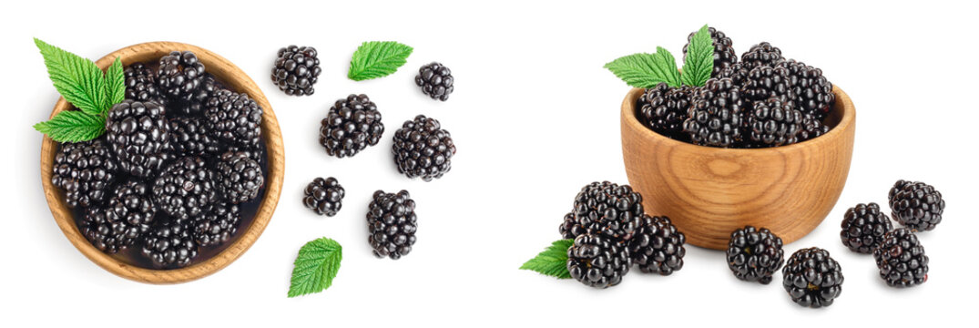 blackberry with leaf in wooden bowl isolated on a white background closeup