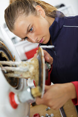 plumber woman builder fixing heating system