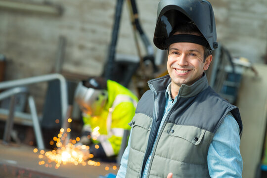 portrait of man wearing raised welding mask