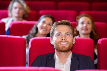 one man sitting in cinema or theater auditorium