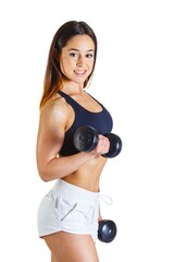 Fototapeta premium Workout of sporty smiling bodybuilder cheerful girl training making exercise pumping up muscles of hands with two dumbells muscular woman in white shorts black top on a white background