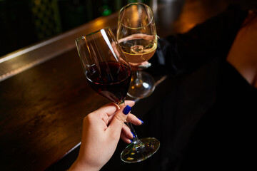 Clinking glasses with alcohol and toasting, party.