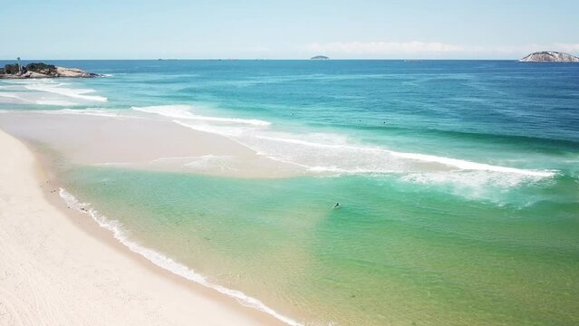 drone view of trees and sea at ipanema with surfists