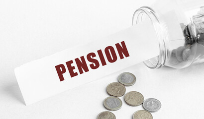 Paper with the text PENSION in a glass jar on a background of coins