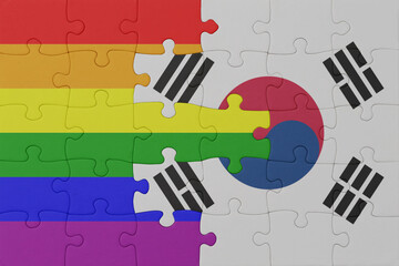 puzzle with the flag of rainbow gay pride and south korea . macro.concept.