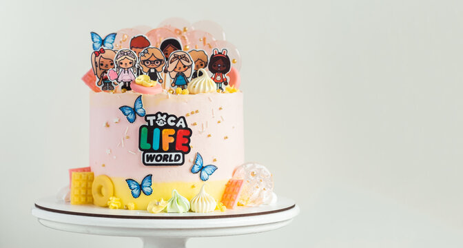 KYIV, UKRAINE - April 01: Birthday cake for a little fan of Toca Life World video game. Pink cake for a girl on the white background