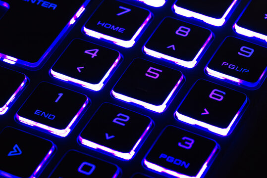 laptop keyboard numeric pad with blue lighting close-up