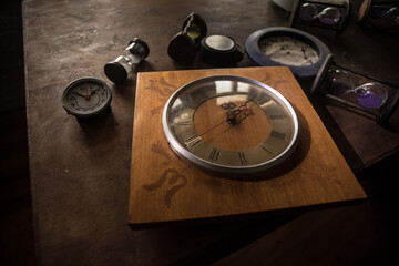 Time concept. Old rustic wall clock on old wooden table with copy space