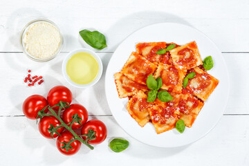 Ravioli pasta meal from Italy for lunch dish with tomato sauce top view on a plate and wooden board