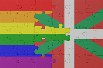 puzzle with the flag of rainbow gay pride and basque country . macro.concept.