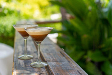 Two glasses of espresso martini at a beach bar in the Maldives