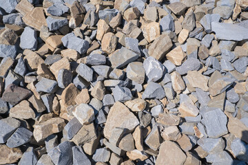 Gravel texture. Pebble stone background. Light grey closeup small rocks. Top view of ground gravel road