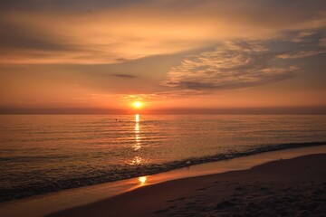 Fototapeta premium Beautiful colorful landscape on the beach by the sea. Sunrise over the Baltic Sea in Jastarnia, Poland.