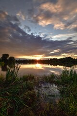 Fototapeta na wymiar Beautiful colorful landscape by the lake in the countryside. Sunset on the Mojcza lake near Kielce, Poland.