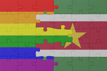 puzzle with the flag of rainbow gay pride and suriname . macro.concept.