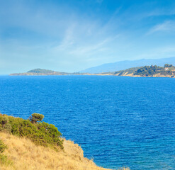 Fototapeta na wymiar Summer Aegean Sea coast landscape (Ormos Panagias, Halkidiki, Greece).