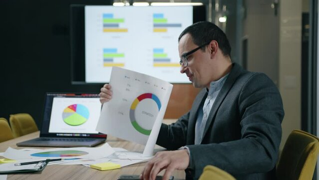 Close-up of financial expert showing annual results in a conference. Portrait of caucasian man brainstorming to resolve a problem. High quality 4k footage