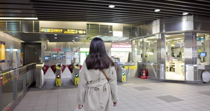 Taipei, Taiwan 18 January 2023: Woman go out of the metro station by using easy card
