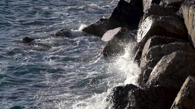 Stormy beautiful waves are crushing on huge rocks on the sea coast in Cadiz.