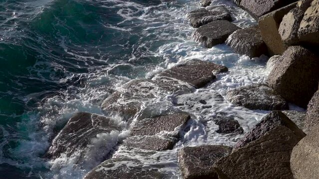 Stormy beautiful waves are crushing on huge rocks on the sea coast in Cadiz.