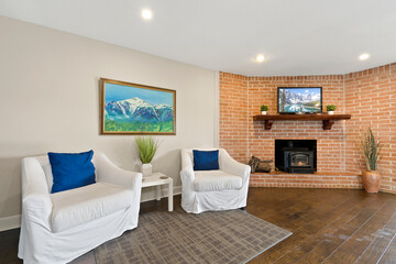 a cozy living room with a brick fireplace