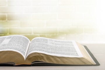 Open Bible book on wooden table