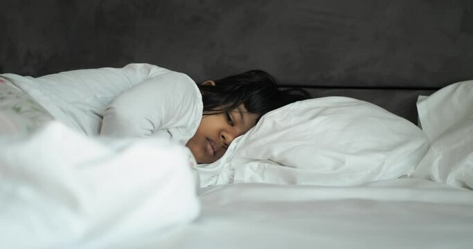 child girl sleeping on bed 