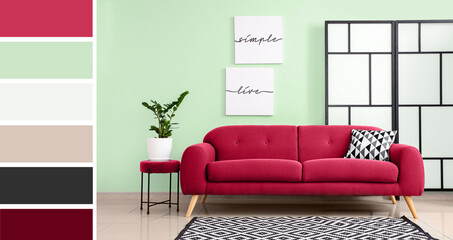 Viva magenta sofa near mint wall in interior of living room. Different color patterns
