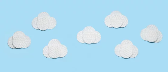 Fotobehang Clouds made of cotton pads on light blue background © Pixel-Shot