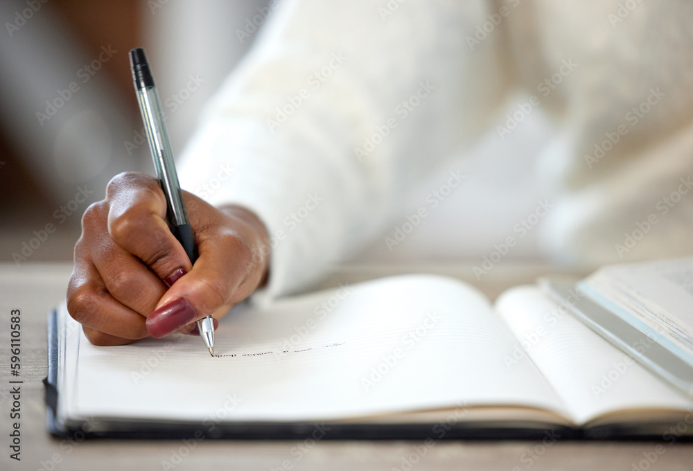 Poster I get every goal I go after. an unrecognisable woman making notes in a book while studying at home.