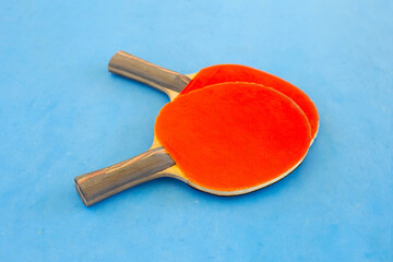 Table tennis equipment rackets on blue table