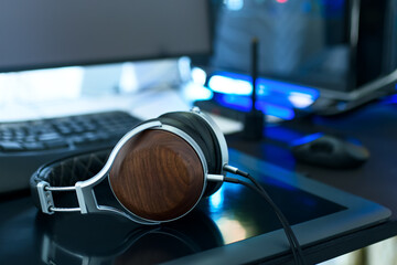Modern computer workspace, focus on headphones on drawing tablet