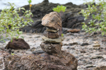 Pile of rocks shaped like a tower at a beach