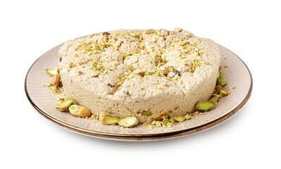 Plate of tasty Tahini halva with pistachios on white background