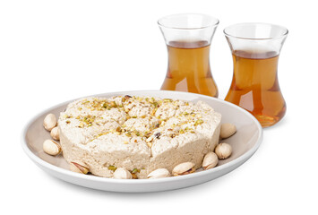 Tasty Tahini halva with pistachios and glasses of Turkish tea on white background