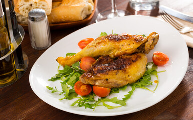 Roasted chicken thighs with arugula and tomatoes. Healthy dinner