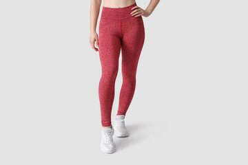 Sporty young woman in leggings on white background