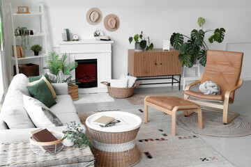 Interior of cozy living room with sofa, armchair and fireplace