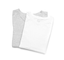 Folded stylish t-shirts on white background