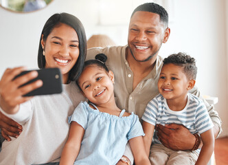 Frozen to be cherished. a young family taking a selfie while bonding together on a sofa.