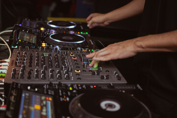 dj playing music on professional dj equipment,