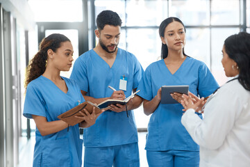 Coming together as the top in their field. a group of medical practitioners having a discussion in a hospital. - Powered by Adobe