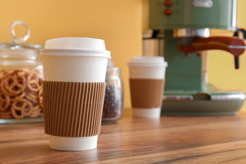 Takeaway cup in coffee break area, closeup