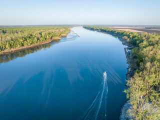 Obraz premium spring sunrise over the Missouri River with a fishing boat at Dalton Bottom - aerial view
